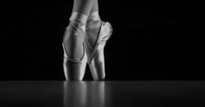 black and white photo of a ballerina wearing ballet shoes