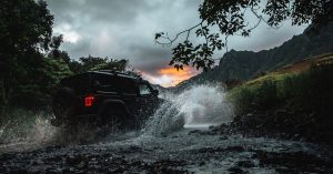 2020 Jeep Wrangler off roading in a stream