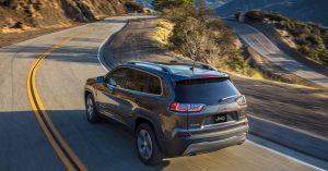 2020 Jeep Cherokee in grey driving down a curvy road