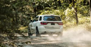 2020 Dodge Durango in white, driving down a dirt road