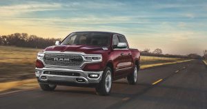 2020 Ram 1500 in red driving down a country road