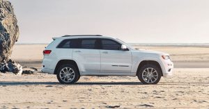 2020 Jeep Grand Cherokee in white on a sandy beach