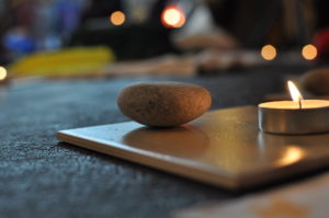 a calming stone and a lit candle