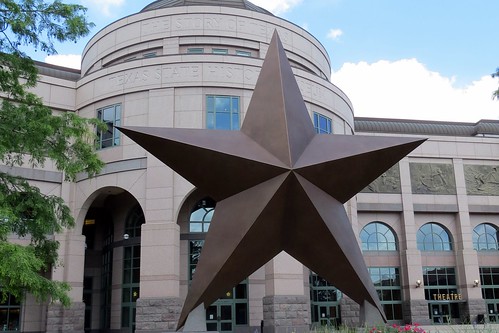 the dallas star in front of the capital building
